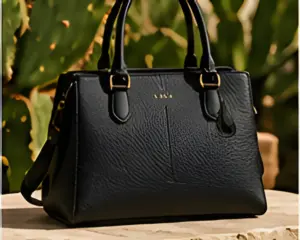 A black structured handbag on a stone ledge